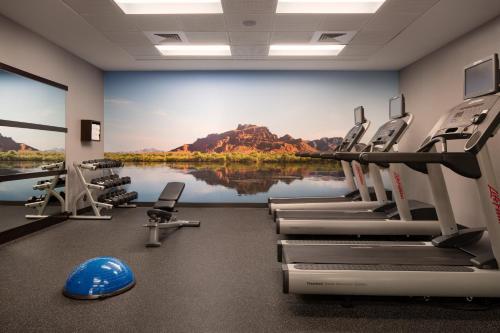 a gym with chairs and a large painting on the wall at Courtyard by Marriott Scottsdale Salt River in Scottsdale