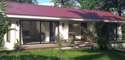 a small house with a wooden porch in the yard at Forest garden residence in Bilar