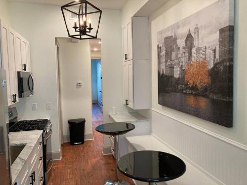 a kitchen with a table in the middle of a room at La Belle Veranda Villa- 3QueenBeds/2Baths Sleeps 6-8 in New Orleans