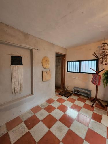 a room with a checkered floor and a window at The Suite. Few steps & beach! in Chelem