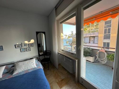 a bedroom with a bed and a large window at TERRAZZA vista MARE - SEA view Terrace in Sanremo