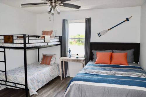 a bedroom with two bunk beds and a window at Peaceful Family Lake House in Jacksonville