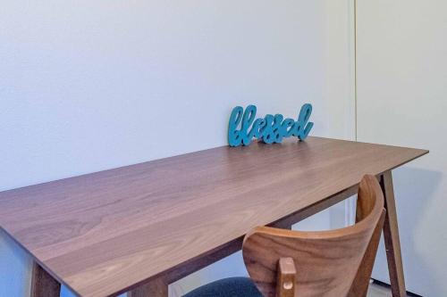 a wooden table with a wooden chair in a room at Stylish 2B2B country style house in Glendora