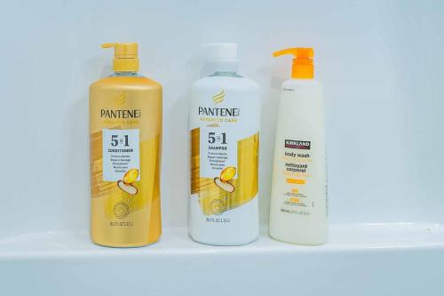 four bottles of orange liquid sitting on a shelf at Stylish 2B2B country style house in Glendora