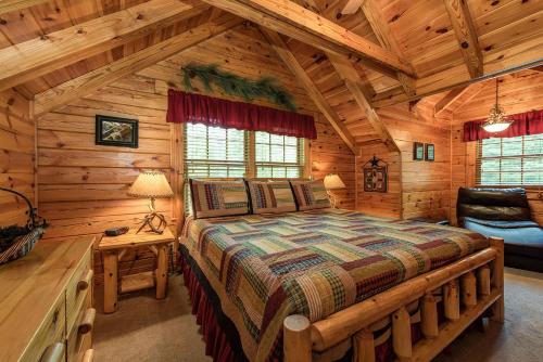 a bedroom with a large bed in a log cabin at Return To Me, 3 Bedrooms, Sleeps 9, Pool Table, Hot Tub, Gas Fireplace in Sevierville
