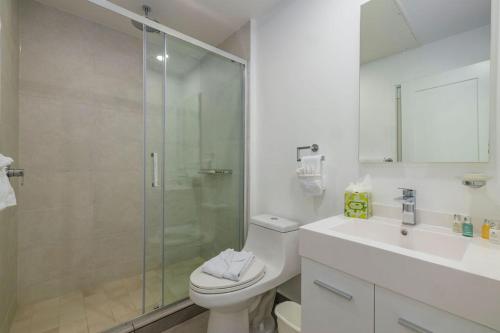 a bathroom with a shower and a toilet and a sink at Hh-3Bs612 - Amazing Beach Condo Oceanfront In Aruba! in Oranjestad