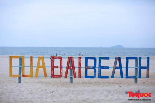 a sign on a beach with the word maladed at Sea and Sand Hotel in Hoi An