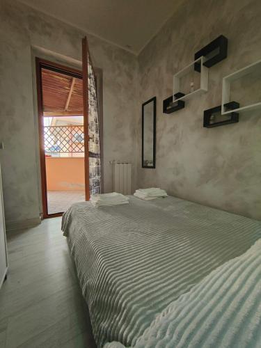 a bedroom with a large bed and a window at Roma Grey Suite in Rome