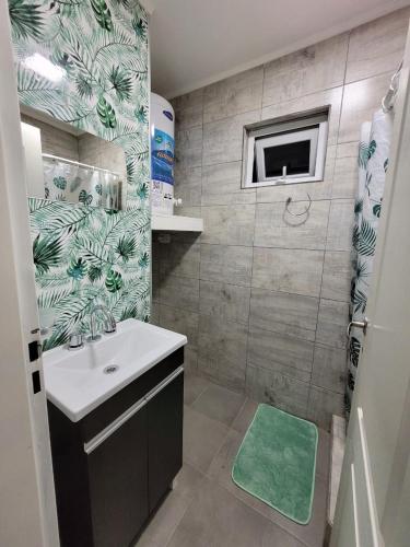 a small bathroom with a sink and a shower at Departamento Desire in Puerto Deseado