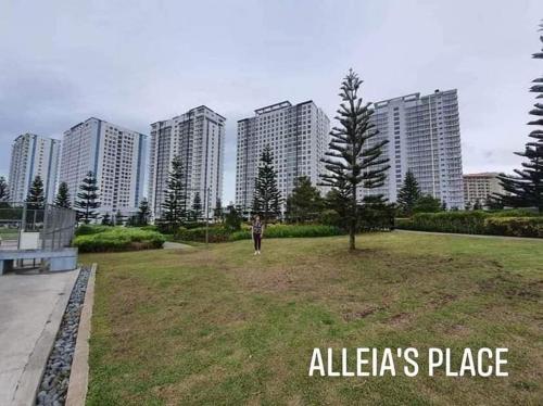 a person standing in a park with tall buildings at Alleia's Place at Tagaytay in Tagaytay