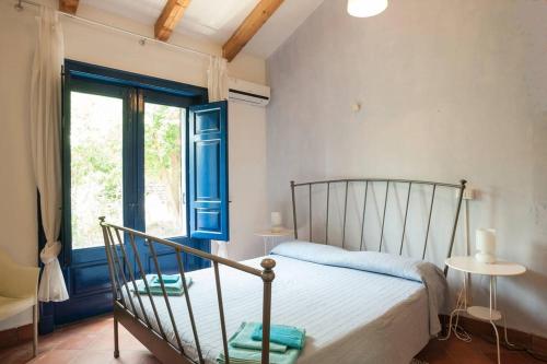 a bedroom with a bed and a window at Come In Sicily La Pietra Monaca in Acireale