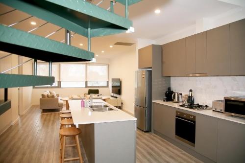 a large kitchen with a counter and a kitchen island at Hilton Executive Apartments in Keswick