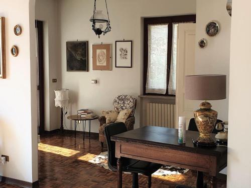a living room with a table and a chair at Vesime Villa with Garden in Vesime
