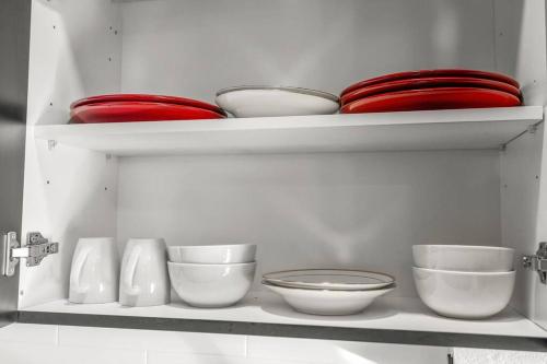 a white shelf with bowls and plates on it at Pure Relaxation-Luxury/Roof Top* in Philadelphia