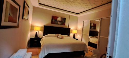 a small bedroom with a bed and a mirror at Habitaciones Narvarte Del Valle in Mexico City