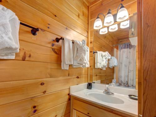 a bathroom with a sink and a mirror at Macys Hideaway, 1 Bedroom, Hot Tub, WiFi, Sleeps 7 in Sevierville