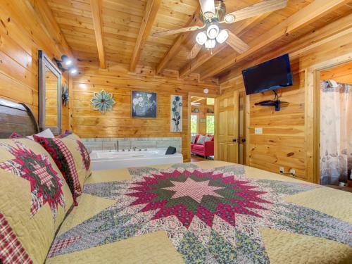 a bedroom with a bed and a ceiling fan at Macys Hideaway, 1 Bedroom, Hot Tub, WiFi, Sleeps 7 in Sevierville