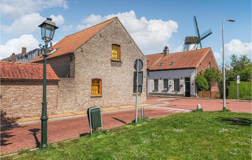 a building with a street light and a windmill at 2 Bedroom Gorgeous Home In Ijzendijke in IJzendijke