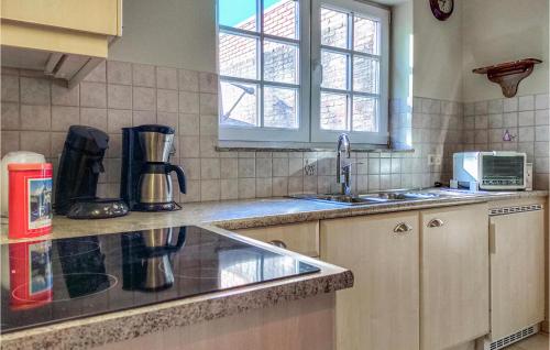 a kitchen with a sink and a counter top at 2 Bedroom Gorgeous Home In Ijzendijke in IJzendijke