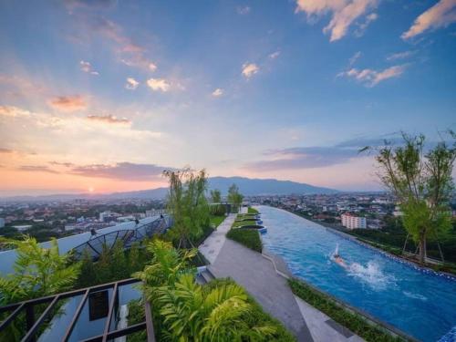 a pool on top of a building with a city at Astra Sky River Pool By Duke 07 in Chiang Mai