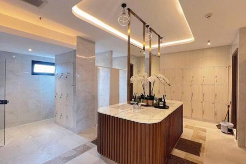 a large bathroom with a shower and a sink at Astra Sky River Pool By Duke 07 in Chiang Mai