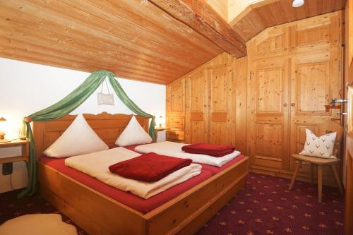 Un dormitorio con una cama en una habitación de madera. en Obersteinberg-Hof inkl. Chiemgaukarte, en Ruhpolding
