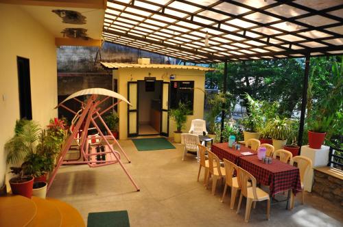 a patio with a table and a play set at Hotel Oasis in Mount Ābu