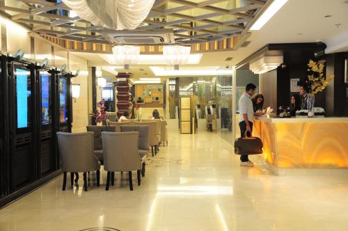 a man with a suitcase standing in a restaurant at Grand Star Hotel Bosphorus & Spa in Istanbul