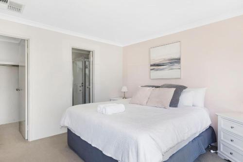 a white bedroom with a large white bed in it at Sandylands Busselton with WiFi in Vasse