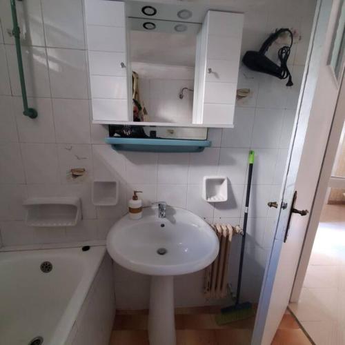 a white bathroom with a sink and a shower at HOME away from home_3BR at Maniatika_14min walk to the port in Piraeus