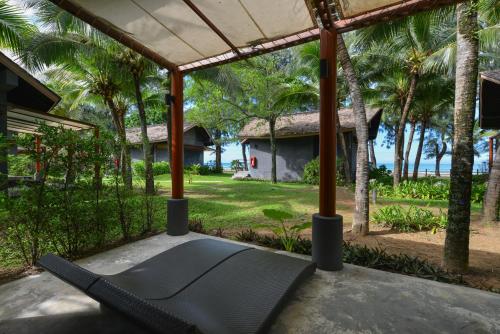 a hammock on the porch of a house at Twin Lotus Resort and Spa - SHA Plus - Adult Only "November - April" in Ko Lanta