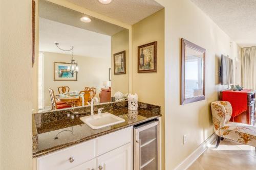 a bathroom with a sink and a dining room at Majestic Beach Resort Tower 2- 801 in Panama City Beach