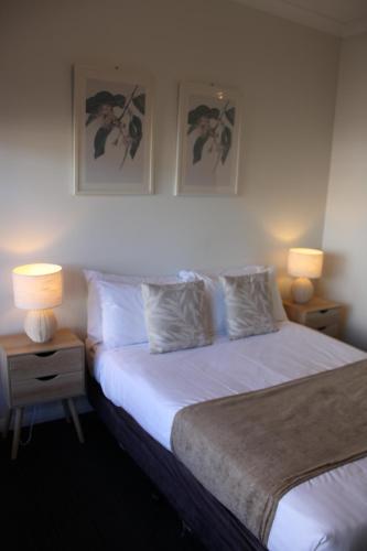 布萊特（Bright）的住宿－布萊特阿爾平汽車旅館，一间卧室配有一张带两盏灯的床。