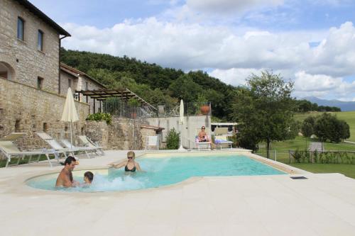 a group of people playing in a swimming pool at Relais Villa D'Assio in Labro Rieti