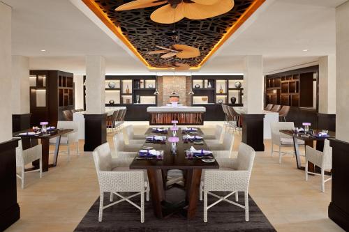 a dining room with a large table and chairs at Banana Island Resort Doha by Anantara in Doha
