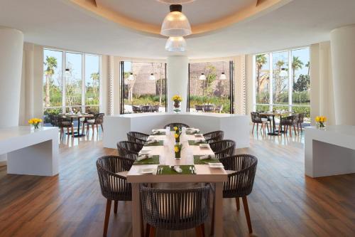 a dining room with a table and chairs at Banana Island Resort Doha by Anantara in Doha
