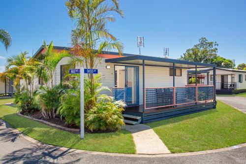 a house with a street sign in front of it at Pyramid Holiday Park in Tweed Heads