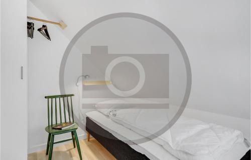 a bedroom with a bed with a mirror and a chair at Stunning Home In Nørre Nebel in Nørre Nebel