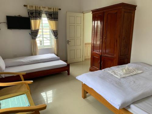Un ou plusieurs lits dans un hébergement de l'établissement Nhà nghỉ Chiều Tím