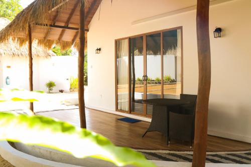 a room with a table and a view of the ocean at The Blue Lagoon Resort Kalpitiya in Kalpitiya
