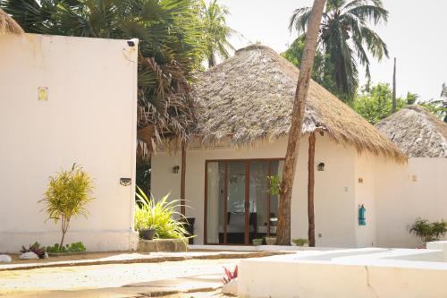 a house with a thatched roof at The Blue Lagoon Resort Kalpitiya in Kalpitiya