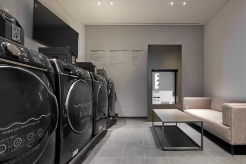 a row of washers and dryers in a room at Shilla Stay Yeosu Expo Station in Yeosu