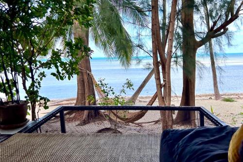 a hammock on a beach with the ocean at BEACH BUNGALOW - OUTDOOR net on the beach - Working Desk in Lipa Noi