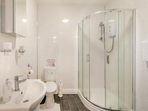 a bathroom with a shower and a sink and a toilet at The Bungalow in Denby