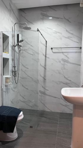 a bathroom with a shower and a toilet and a sink at PoolVilla Breeze Valley in Cha Am