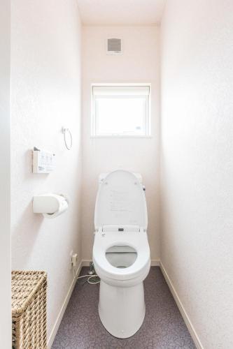 a bathroom with a toilet and a window at ふくろう庵-白浜- in Shirahama