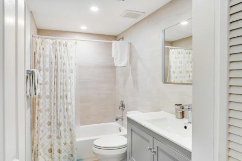 a bathroom with a sink and a toilet and a tub at Nauti Hideaway, Unit #2314 in Tavernier