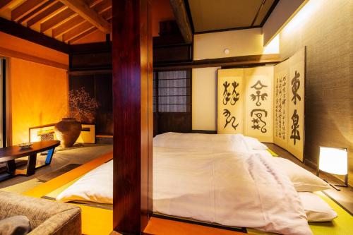 a bedroom with a bed and a couch at Sumiya Rakusuitei - Vacation STAY 16647v in Takayama