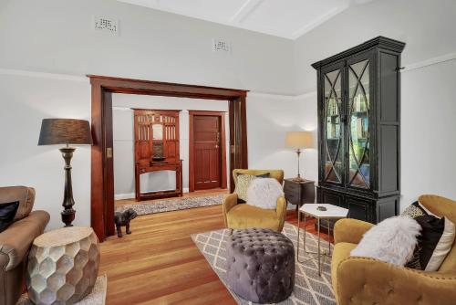 a living room with furniture and a fireplace at Carcoola in Blackheath