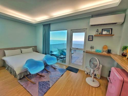 a bedroom with a bed and a room with a balcony at A Promised Land BnB in Jiufen